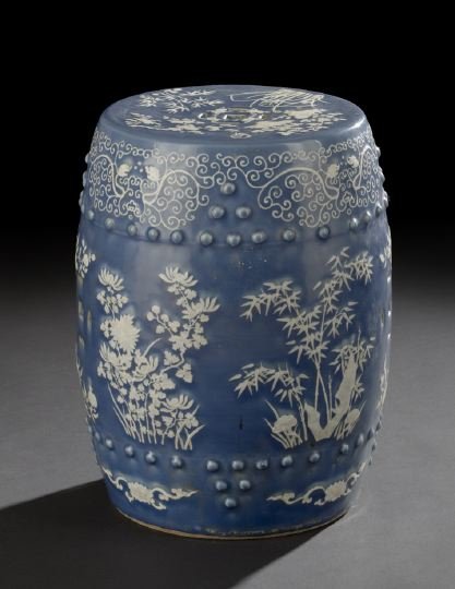 Chinese Blue & White Slip-Decorated Garden Seat: Chinese Blue and White Slip-Decorated Porcelain Garden Seat, 19th century, of barrel form with pierced "cash" symbols and two rows of molded bosses, the blue ground with white slip decoration of flowe