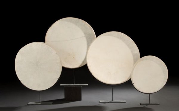 Striking Set of Four Graduated Vellum Drumheads: Striking Set of Four Graduated Vellum Drumheads, now mounted on matching custom wrought-steel display stands, overall h. 16" to 24-1/8", dia. 11-1/2" to 18".