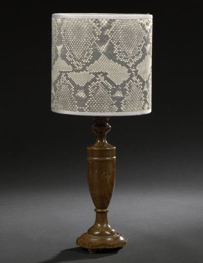 English Oak Candlestick: English Oak Candlestick, early 20th century, now mounted as a table lamp, the turned vasiform standard raised on a molded octagonal base on bun feet, fitted with a custom gray python drum shade with g