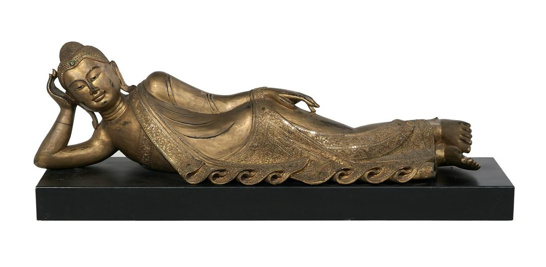 Giltwood Reclining Asian Female Figure: Near Life-Size Carved Giltwood Reclining Asian Female Figure 20th century, dressed in traditional costume with inset faux jewels and resting on a rectangular ebonized base. h. 22", w. 62", d. 15" Prov