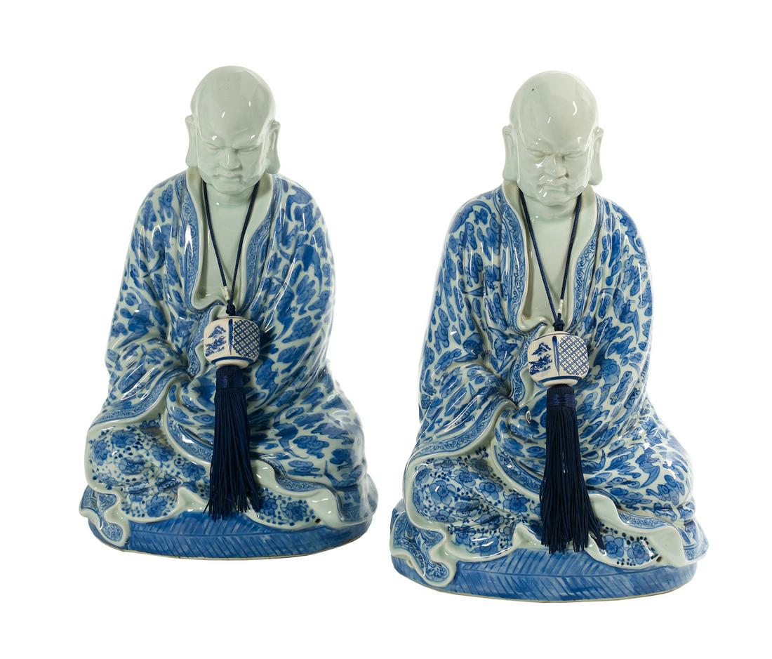 Pair of Chinese Blue and White Porcelain Figures: Pair of Chinese Blue and White Porcelain Figures 20th century, each depicting an elder seated with legs crossed and cloaked in a robe. h. 16", w. 9", d. 7" Provenance: The Estate of Bonnie Bolding Swe