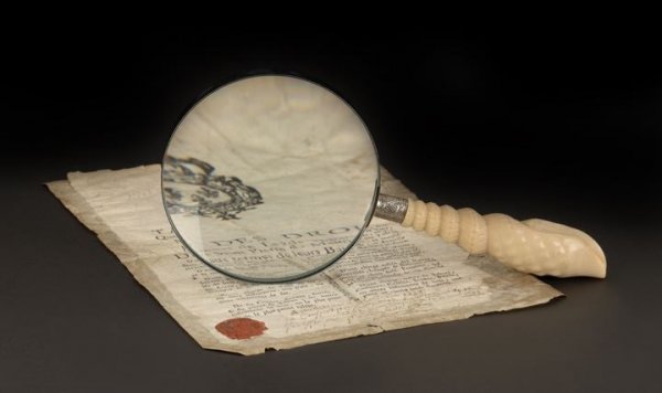 Victorian Carved Ivory Desk Magnifier: Victorian Carved Ivory Desk Magnifier, 1895 and later, the handle carved from a single piece of ivory in the form of a seashell, with an embossed sterling silver ferrule hallmarked Sheffield, 1895-189