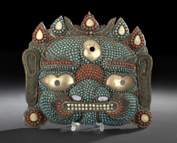 Large and Unusual Nepalese Mask of Bhairab: Large and Unusual Nepalese Mask of Bhairab, the copper mask fashioned as a grimacing visage wearing a flaming headdress, the face decorated with coral and turquoise cabochons, the eyes inset with yell