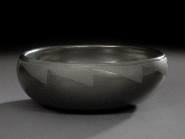 San Ildefonso Pueblo Black-on-Black Pottery Bowl: San Ildefonso Pueblo Black-on-Black Pottery Bowl, by Blue Corn, a.k.a. Crucita Gonzales Calabaza (1921-1999), the squat polished bowl decorated with matte lightning-banded rim, the base signed in sgra