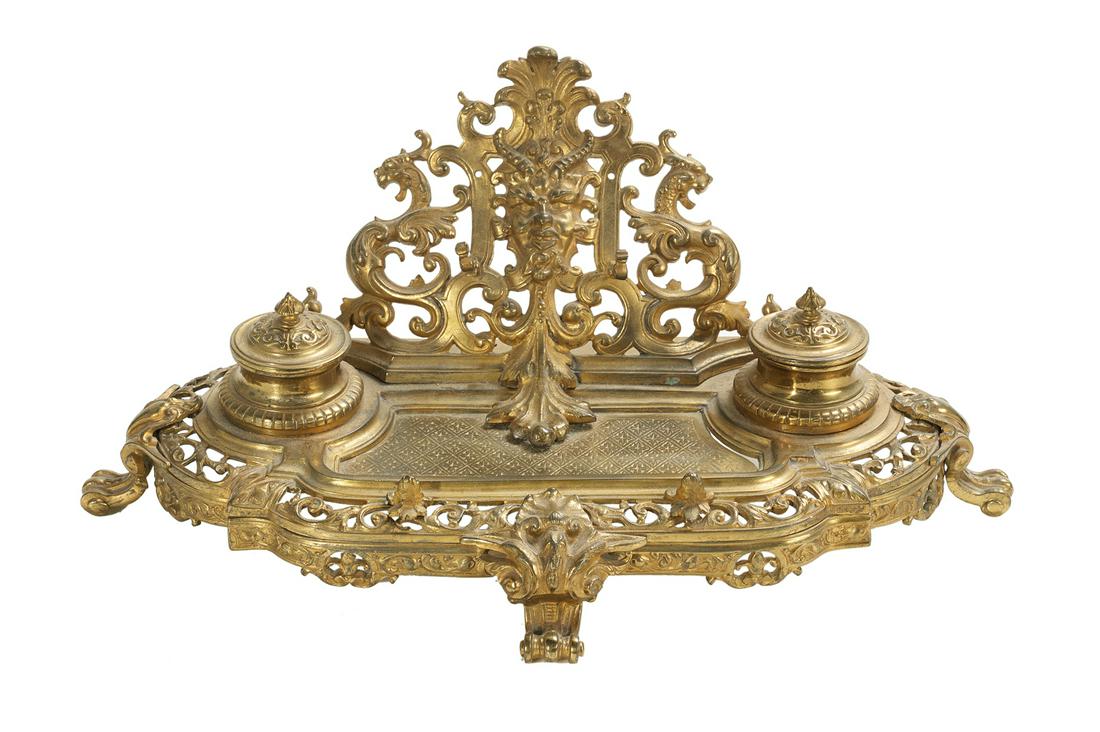 French Gilt-Bronze Encrier: French Gilt-Bronze Encrier ca. 1900, in the Renaissance taste, the base raised on paw feet and set with two inkpots with hinged covers, the pierced backplate set with a pen holder beneath a satyr masq