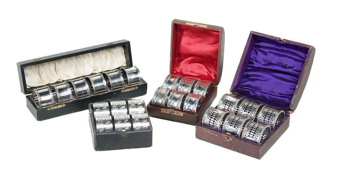 Cased Sets of Edwardian Silverplate Napkin Rings: Four Cased Sets of Edwardian Silverplate Napkin Rings late 19th/early 20th century, each set with six napkin rings, including: A set of oval shape with waisted body and beaded and reeded banding, h. 7