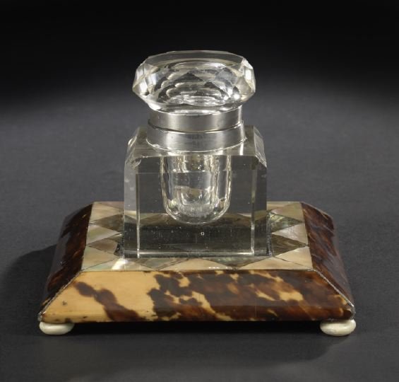Tortoiseshell and Mother-of-Pearl Inkstand: Edwardian Tortoiseshell and Mother-of-Pearl-Inlaid Inkstand, ca. 1900, fitted with a cut glass ink jar of square form, the square graduated base raised on polished bone bun feet, h. 3", w. 4", d. 4".