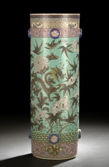 Chinese Export Molded Porcelain Umbrella Stand: Chinese Export Molded Porcelain Umbrella Stand, of cylindrical form with molded floral bosses, decorated in famille rose enamels with a continuous scene of rampant dragons among asters and peonies on 