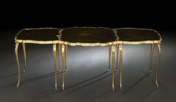 French Brass and Mirrored Glass Cocktail Table: French Gilt-Brass and Smoked Mirrored Glass Cocktail Table, of tripartite form in the Louis XV taste, the ends separating to form two separate chairside tables, the whole supported on a dozen slender 