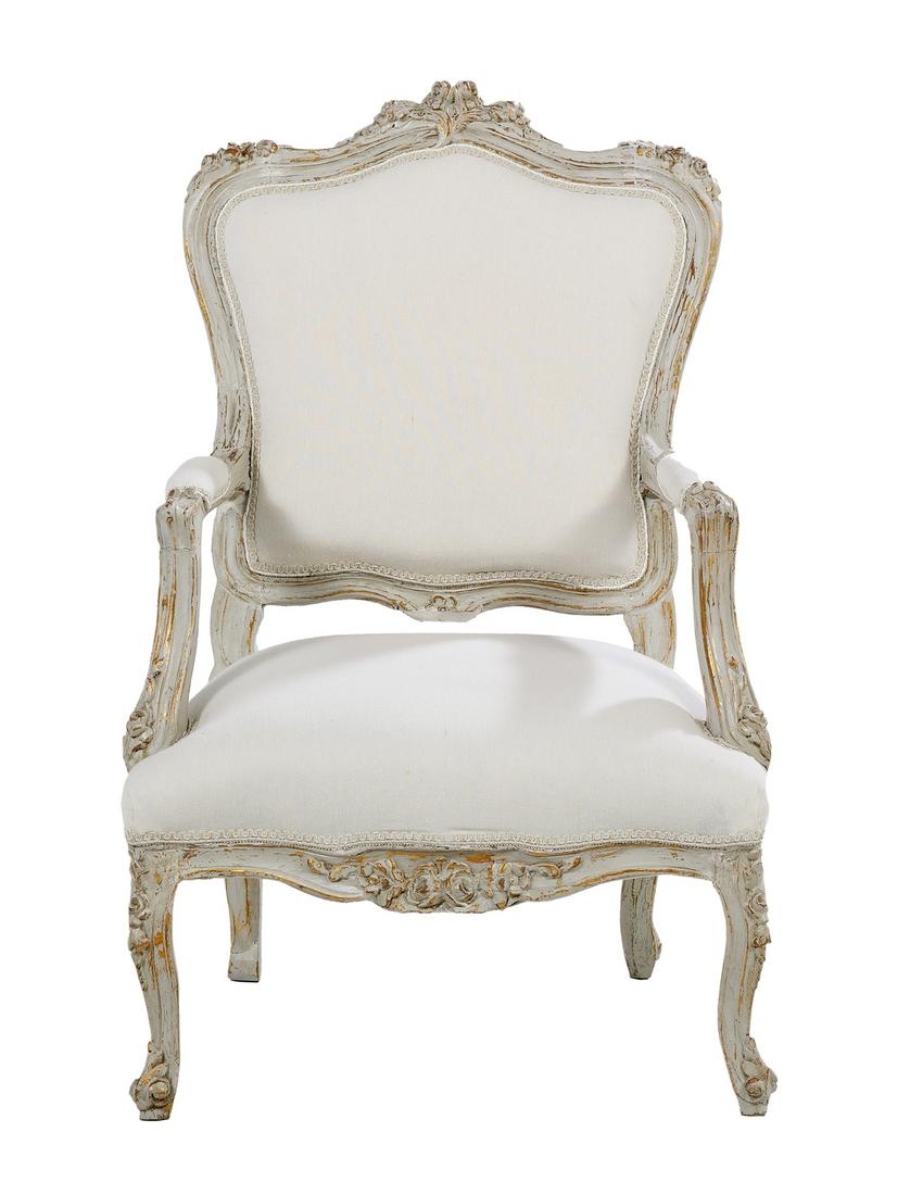 Napoleon III-Style Parcel-Gilt Fauteuil: Napoleon III-Style Creme-Peinte and Parcel-Gilt Fauteuil 20th century, the shaped and padded back surmounted by a floral crest, joined by padded arms to the like seat, above a floral-carved apron, rai