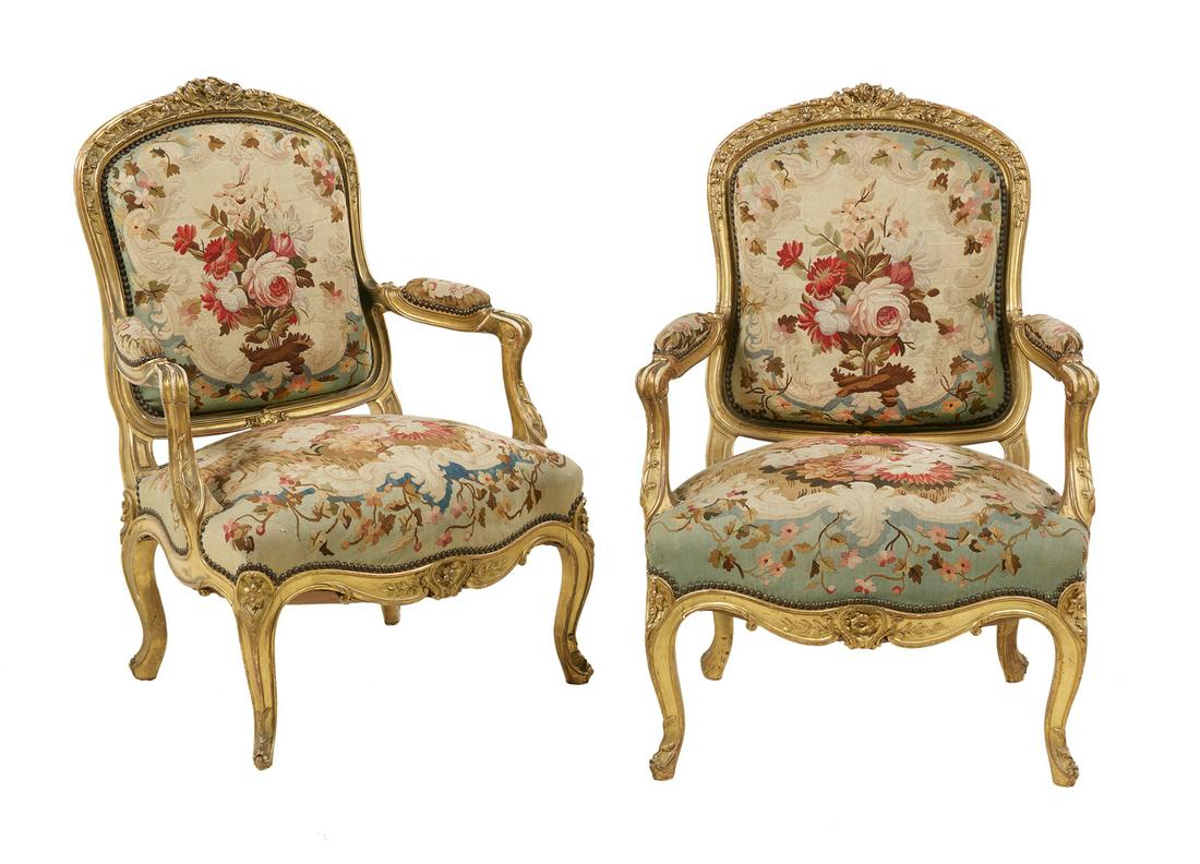 Pair of Napoleon III Giltwood Fauteuils: Pair of Napoleon III Giltwood Fauteuils mid-19th century, in the Louis XV style, each with an elaborate foliate crest above the rounded and padded back, joined by scrolling arms to the padded seat, ra