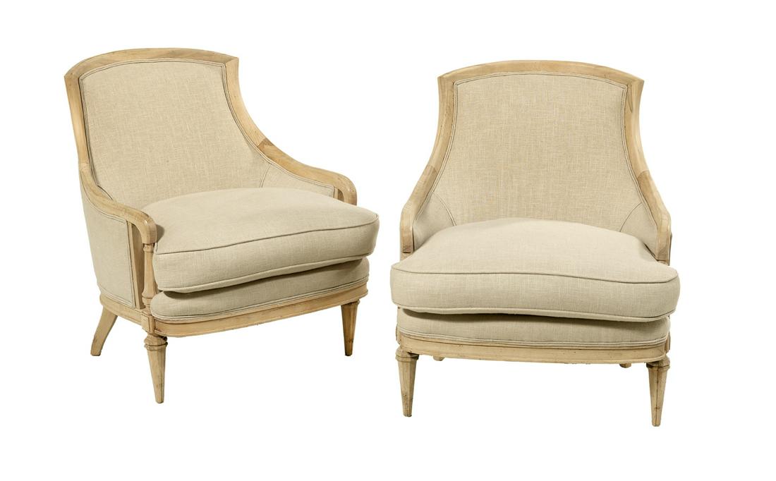 Pair of Louis XVI-Style Beechwood Bergeres: Pair of Louis XVI-Style Beechwood Bergeres each with a padded back joined by downswept arms and paneled uprights to the cushioned seat, raised on paneled tapering circular legs. h. 33"