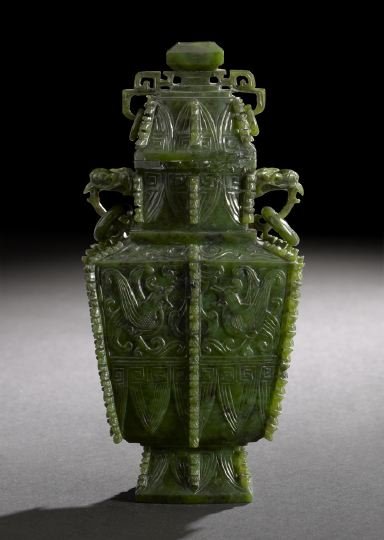 Chinese Carved "Spinach" Jade Covered Vase: Elaborate Chinese Carved "Spinach" Jade Covered Vase, after a Shang Dynasty bronze vessel, flanges, of flattened quadrangular form with conforming cover, the neck with loose ring bird-head handles, th
