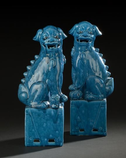 Pair of Chinese Porcelain Foo Dogs: Pair of Chinese Porcelain Foo Dogs, comprised of a male with a ball under his left paw and a female with a cub under her right paw, both dogs seated on their haunches atop open plinth bases and glazed