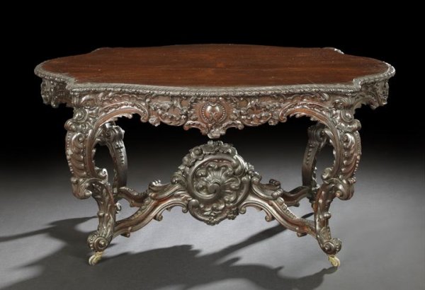 American Rococo Revival Rosewood Center Table: Fine and Large American Rococo Revival Rosewood Center Table, mid-19th century, attributed to Alexander Roux, New York, the tortoise-form top with gadrooned edge, over a highly carved conforming apron