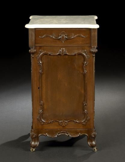 American Rococo Revival Rosewood Night Stand: American Rococo Revival Rosewood Night Stand, third quarter 19th century, possibly by J. and J. W. Meeks, New York, the marble top with ovolo corners, the conforming case with a drawer over a door wit