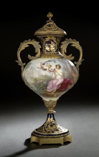 French Bleu-du-Roi-Ground Garniture Vase: French Bleu-du-Roi-Ground Porcelain Covered Garniture Vase, fourth quarter 19th century, the gilt-lacquered brass-mounted two-handled vase richly polychromed and gilded in the Louis XVI Sevres style, 