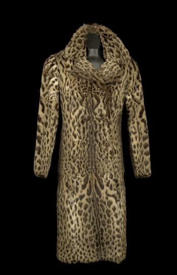 Ocelot Coat: Ocelot Coat, ca. 1950's, purchased in Paris by the consigner, the double-breasted coat has long sleeves and a collar with lapels, the pelts vertical, the buttons are metal and have been replaced, as h