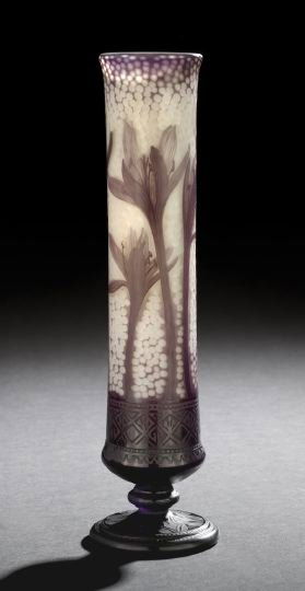 Daum, Nancy, Cameo-Cut Glass Footed Vase: Daum, Nancy, Cameo-Cut Glass Footed Vase, ca. 1900, the amethyst over opalescent white vase of nozzle form in "Crocus" decor, the ground of the nozzle body martele cut, signed on the base in incised s