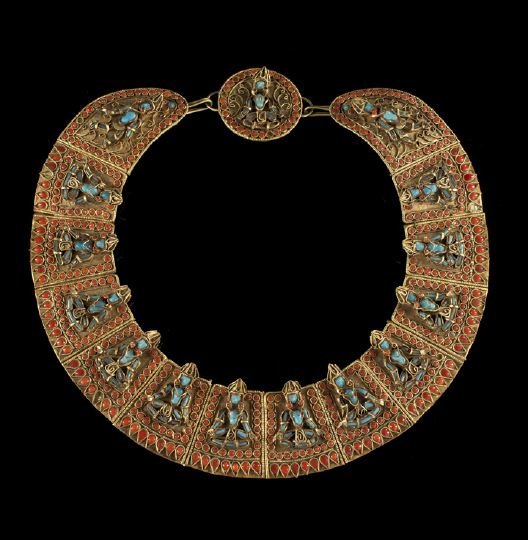 Himalayan Turquoise and Coral Necklace: Himalayan Gilt-Metal, Turquoise and Coral Necklace, composed of fifteen shaped links each with a crowed Buddhist figure bordered in coral round and shaped cabochons.