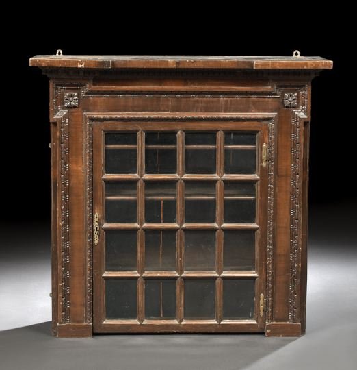 George III Mahogany Hanging Cabinet: George III Mahogany Hanging Cabinet, late 18th century, the molded cornice with projecting corners above a conforming dentillated and egg-and-dart-carved frieze, with a single astragal-glazed door bel