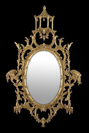 Pair of George III-Style Giltwood Looking Glasses: Pair of George III-Style Giltwood Looking Glasses, in the style of Thomas Johnson (English, 1714-1778), each with an oval plate surmounted by a pierced pagoda-form crest, surrounded by a molded and fl