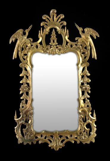 George III-Style Giltwood Looking Glass: George III-Style Giltwood Looking Glass, in the manner of Thomas Johnson (English, 1714-1778), the shaped plate surmounted by a pierced pagoda-form crest with flanking ho-ho birds, within an elaborate