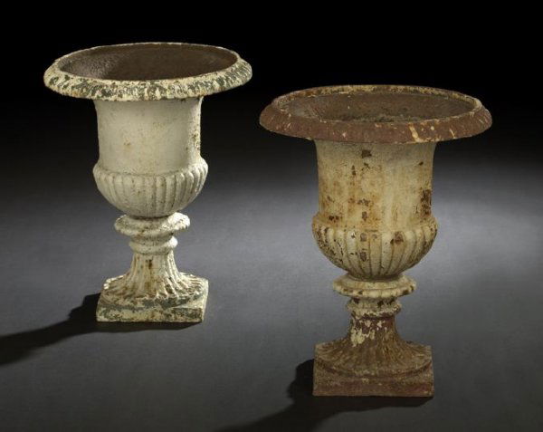 Pair of Neoclassical-Style Cast-Iron Garden Urns: Pair of Neoclassical-Style Cast-Iron Garden Urns, ca. 1900, each of campana form, with ribbed lip, reeded body and fluted base, h. 19", dia. 16".