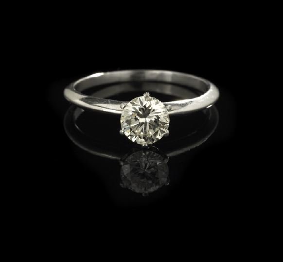 Tiffany Platinum & Diamond Engagement Ring: Tiffany and Company Platinum and Diamond Classic Lady's Engagement Ring, the platinum band topped with a classic six-prong top holding a 1.05-carat round brilliant-cut white diamond.
