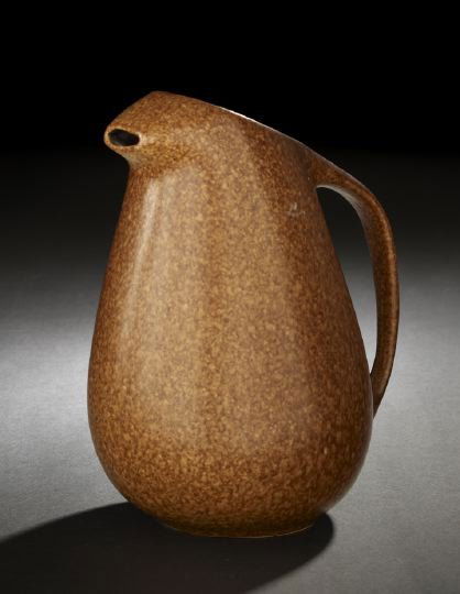 Stylish Roseville Pottery "Raymor" Pitcher: Stylish Roseville Pottery "Raymor" Pitcher, the line introduced in 1952, in speckled cinnamon glaze, the base with embossed marks and numerals, underglaze, h. 10-1/4", w. 7-1/2".