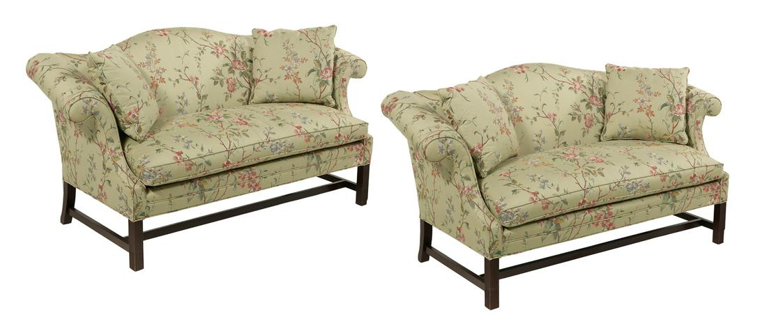 Pair of George III-Style Upholstered Settees: Pair of George III-Style Mahogany and Upholstered Settees 20th century, each with a padded camelback joined by outscrolled arms to the cushioned seat, raised on chamfered square legs. h. 35", w. 70",