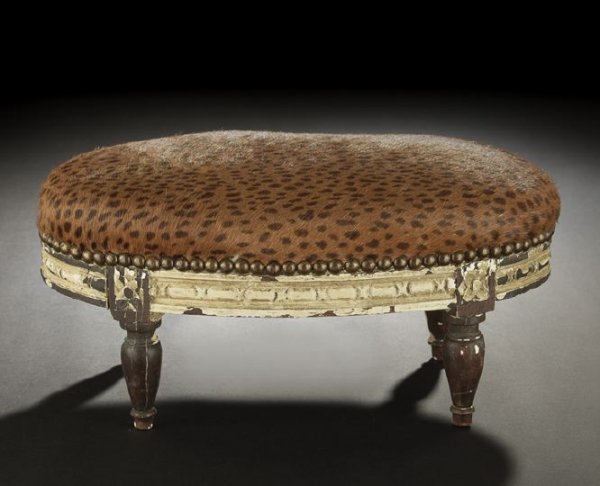 French Carved and Painted Beechwood Footstool: French Carved and Painted Beechwood Footstool, first quarter 20th century, of elliptical form in the Louis XVI style, the gently domed seat upholstered in printed brown-spotted russet fur, the finish 