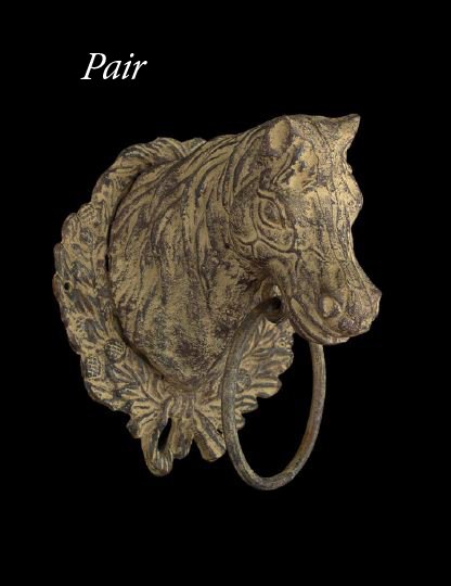 Pair of Edwardian Wall-Hanging Horse Hitches: Large Pair of Edwardian Wall-Hanging Horse Hitches, first quarter 20th century, in the form of wreathed ringed equine heads, presented in a mocha-pickled lightly rusted finish, h. 9-1/2", w. 7-3/4", d