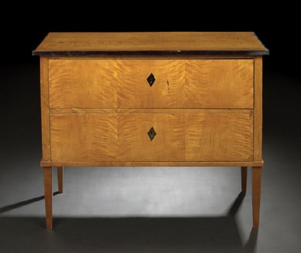 Biedermeier Satinwood Commode: Biedermeier Satinwood Commode, second quarter 19th century and later, the rectangular top within an ebonized banding, above a conforming case fitted with two long drawers, each with ebonized escutcheo