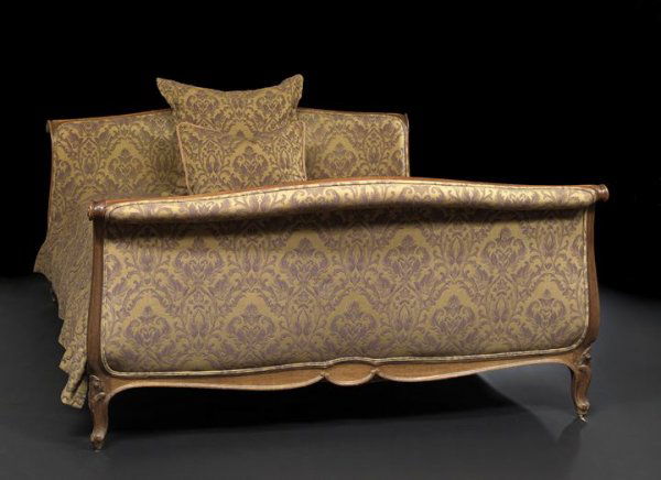 Provincial Louis XV-Style Fruitwood Bed: Provincial Louis XV-Style Fruitwood Bed, early 20th century, the headboard and footboard each with a padded outscrolled crest within a molded frame, both sides padded, joined by padded scroll-paneled