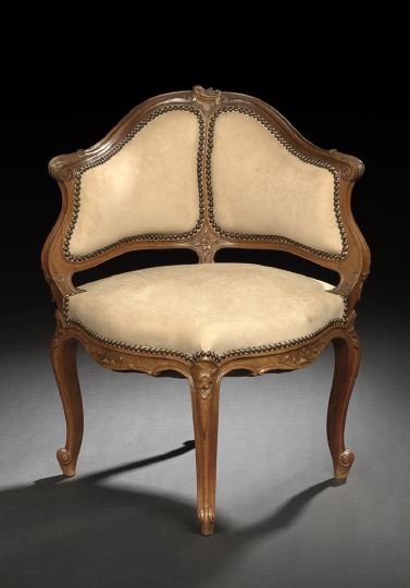 Provincial Louis XV-Style Bergere en Encoignure: Provincial Louis XV-Style Fruitwood Bergere en Encoignure, late 19th century, of diminutive proportions, the bisected and padded back surmounted by a foliate-carved crest, joined by like-carved downsw