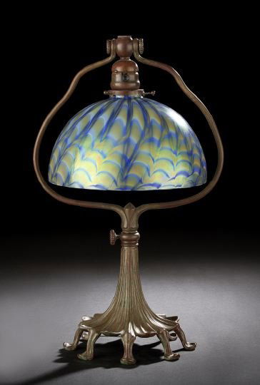 Tiffany Studios-Style Patinated Bronze Table Lamp: Tiffany Studios-Style Patinated Bronze Table Lamp, 20th century, in the Art Nouveau manner, the raised eight-footed adjustable base fitted with a domed iridescent green and periwinkle blue Tiffany "Da