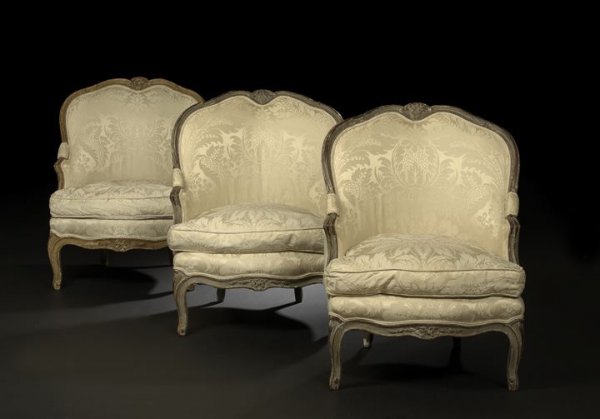 Suite of Three Louis XV-Style Painted Bergeres: Suite of Three Louis XV-Style Painted Bergeres, fourth quarter 19th century, each with a shaped and domed padded back surmounted by a floral-carved crest, joined by closed and padded arms to the cushi