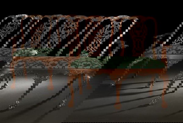 Pair of George III-Style Mahogany Settees: Pair of George III-Style Mahogany Settees, in the Chippendale style, each with a domed double-back with elaborately pierced and carved interlacing splats, joined by outscrolled foliate-carved arms to