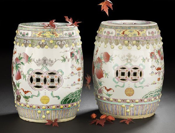 Pair of Chinese Famille Rose Garden Seats: Pair of Chinese Famille Rose Porcelain Garden Seats, each of barrel form with applied bosses and pierced "cash" symbols, decorated with continuous scenes of peaches and bats over waves, with borders a