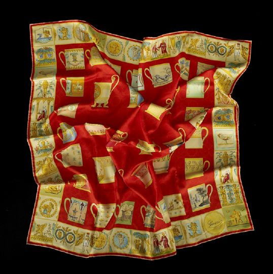 Gucci Silk Scarf: Gucci Silk Scarf, having a red ground decorated with assorted Empire-style coffee cups, the border with various scenes of putti and chinoiserie figures, with a Bergdorf Goodman and Gucci tag attached