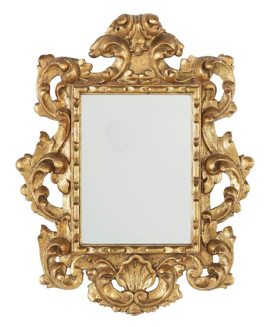Giltwood Mirror in the Italian Baroque Taste: Giltwood Mirror in the Italian Baroque Taste 20th century, the bold surround carved with pierced scrollwork, the crest with an overhanging leaf finial, the lower edge with a scroll-framed shell. h. 29