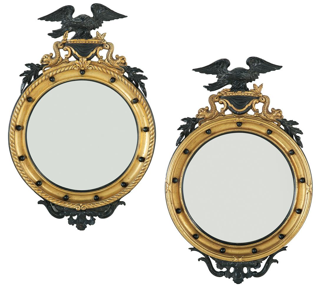 Pair of Eagle-Decorated Giltwood Convex Mirrors: Pair of Eagle-Decorated Giltwood and Ebonized Convex Mirrors mid-20th century, the cove-molded circular surrounds set with ebonized spherules and displayed eagle crests, flanked by dolphins, the lower