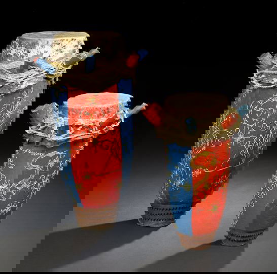 Two Haitian Hardwood and Cowhide Rada Drums: Two Haitian Polychromed Hardwood, Rope and Cowhide Rada Drums, used in Voodoo to call the spirits and induce possession, the pegged and rope-bound cowhide tops with Veve decorations below, both inscri