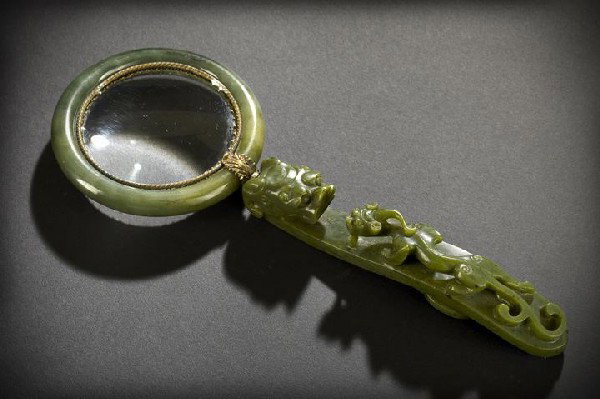 Chinese Spinach Jade Assembled Magnifying Glass: Chinese Spinach Jade Assembled Magnifying Glass, ca. 1930, composed of a spinach jade handle made from a belt hook with hydra dragons and a spinach jade bangle bracelet surrounding the lens, with whit