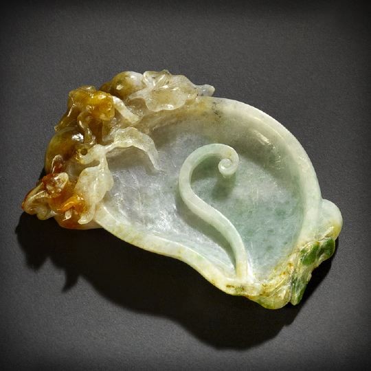 Unusual Chinese Carved Jadeite Brush Washer: Unusual Chinese Carved Jadeite Brush Washer, the green, white and russet mottled stone carved as a leaf with a scrolling tendril and a group of monkeys among foliage at one end, w. 3-1/2", l. 4-1/2".