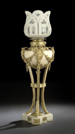 French Gilt-Brass and Marble Salon Lamp: French Gilt-Brass and Carrara Marble Kerosene Salon Lamp, fourth quarter 19th century, in the Louis XVI style, in the form of an antique tripodal brazier, the legs with horned ram's-masque upper termi