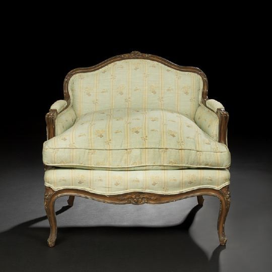 Louis XV-Style Fruitwood Bergere: Louis XV-Style Fruitwood Bergere, late 19th century, the low padded and shaped back surmounted by a floral crest, joined by padded scrolling arms to the cushioned seat, raised on cabriole legs headed 
