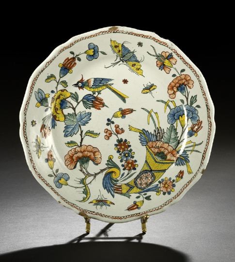 Attractive French Faience Plate: Attractive French Faience Plate,^ fourth quarter 18th century, in "Oiseau, Papillon et Fleur" decor, presented on a later diminutive brass stand of easel form, plate dia. 9-3/4", stand h. 5".