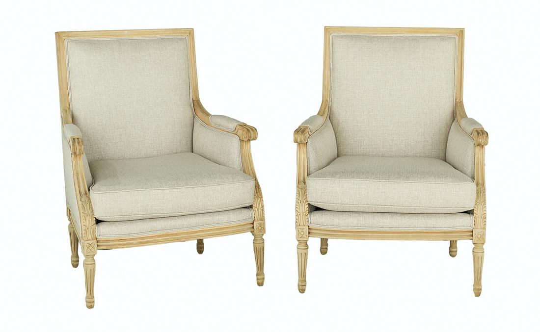 Pair of Louis XVI-Style Beechwood Bergeres: Pair of Louis XVI-Style Beechwood Bergeres each with a padded square back within a molded frame, joined to the cushioned seat by padded arms, raised on fluted tapering circular legs headed by floral b